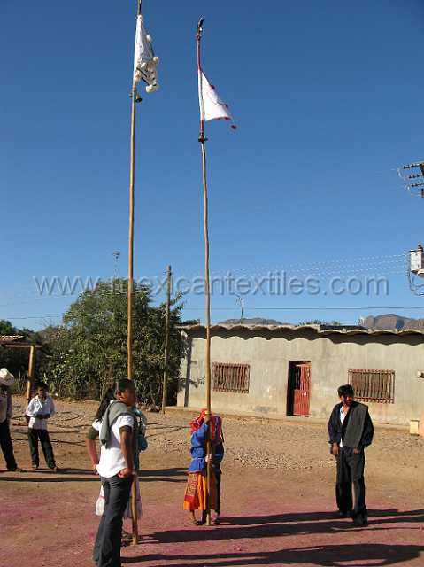 cora_ceremony_04.JPG - Malinches with poles with flags and bells. During the prayers then thumped the poles so that the bells would ring
