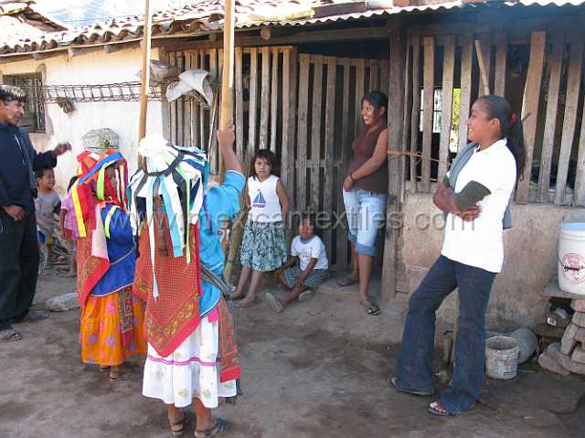 cora_ceremony_09.JPG - In front of a home after singing and prayers, small gifts were given to the group.