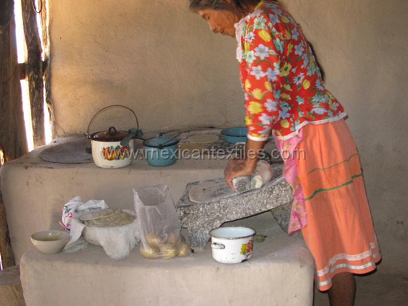 1tepehuano_woman_01.JPG - Tepehuano woman grinding corn to make tortillas in the remote village of Muralitos. This town is at the end of the road. From here paths run down into the San Tomas Canyon , the dividig line between Nayarit and Durango.