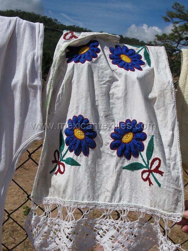 craft.JPG - Documentation ofTepehuano indigenous textiles from Huajicori, Nayarit, Mexico. Embroidered wash cloth drying on a fence in the village center.