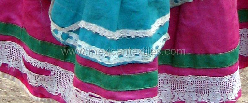 tepehuanodetailskirt.jpg - Detail of lace at the bottom of the blouse with ribbons and lace.
