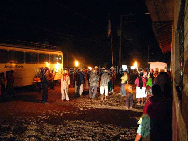 spirutual_life_02.JPG - Pachita in the evening. A young girl is selected as the" Malinche" and carries a large pole with flags and feathers . She is accomanied by the Cora governing body , they pray and chant in front of the homes and the people come out and give sweets and other gifts. This is a prelent ceremony.