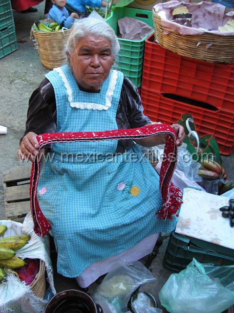 nahua_cuautempan_21.JPG - Weaver from Hueyhueytan selling goods in the market. That belt is now in my collection. Somehow I just can't stop buying things like this knowing she is one of the only weavers.
