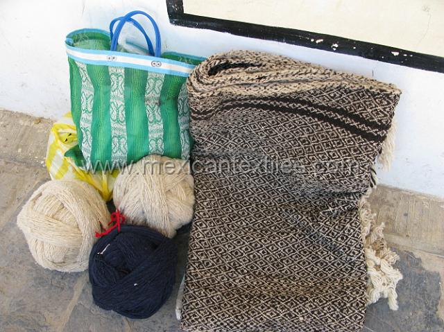 nahua_cuautempan_25.JPG - Hand spun wool balls and a woven blanket.