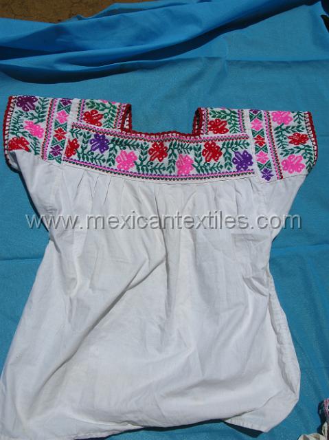 nahuatl_hueytentan_06.JPG - In a number of vilage I saw the older women wearing this style blouse. I like the geometric pattern introducing the sleeve and around the center embroidery.