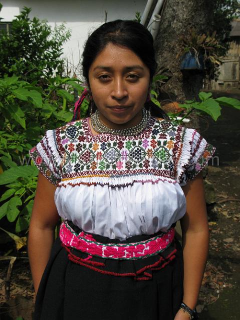 nahua_hueyapan_05.JPG - Young woman wearing the traditional costume of her grandmother. Notice the hand pleated wrap skirt with the red "chickens foot" embroidery and the fantastic blouse.